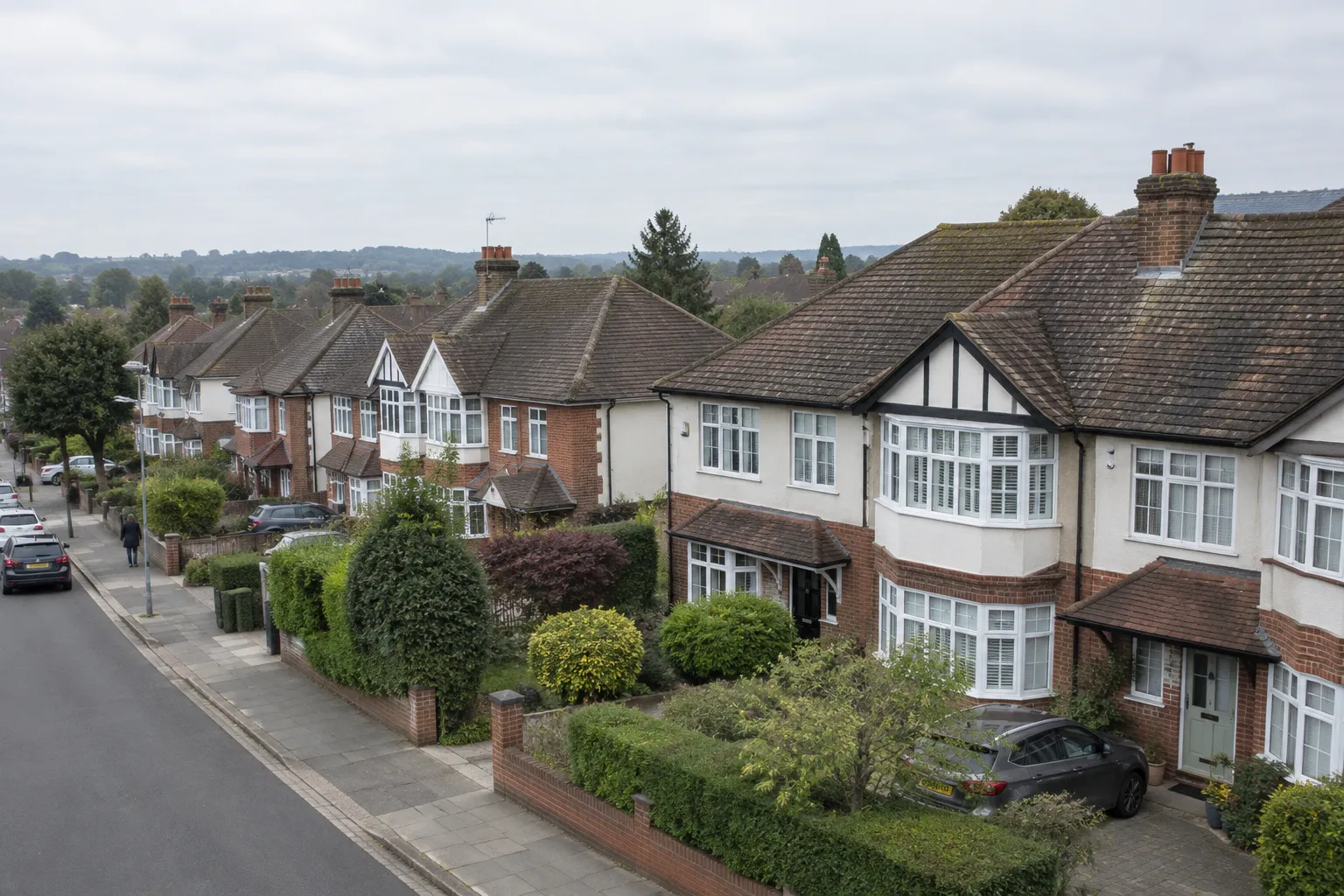 A street of suburban houses with pitched tiled roofs